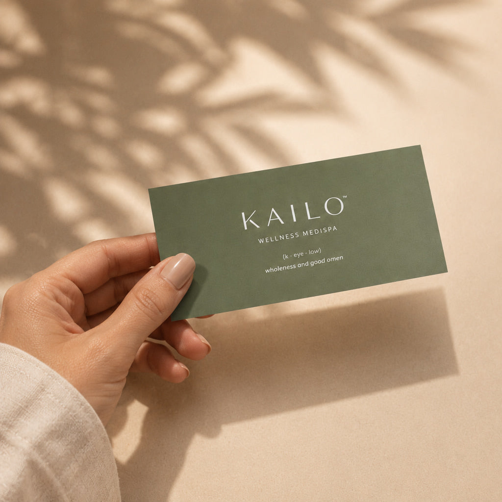 Hand holding a green card with 'Kailo' branding against a beige background